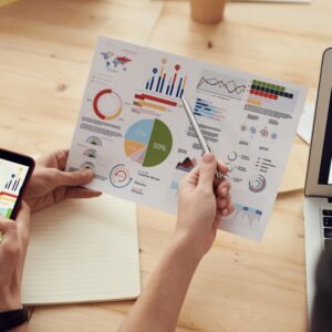 UX surveys results with diagrams and infographics, shown on a paper, phone and laptop