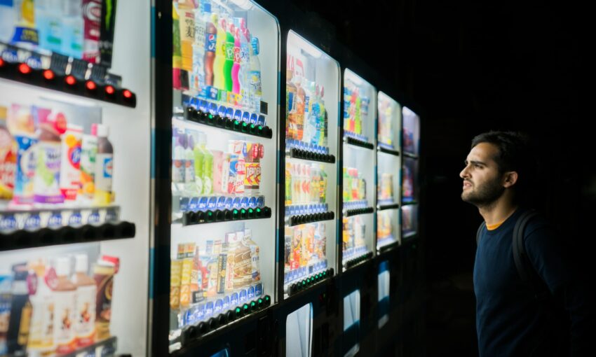 A person having descision fatigue in front of vending machines